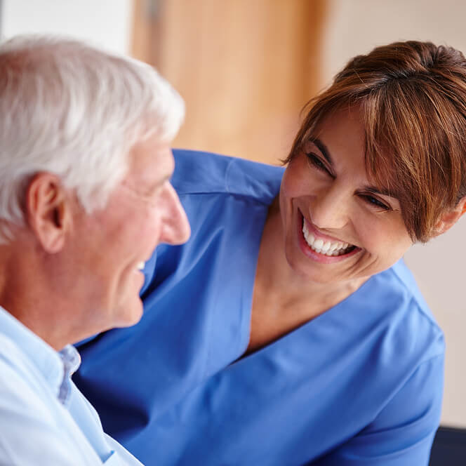 Caregiver Comforting Resident at Memory Care Facility